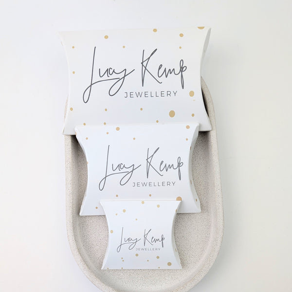 Lucy Kemp Jewellery packaging with gold dots on a white background